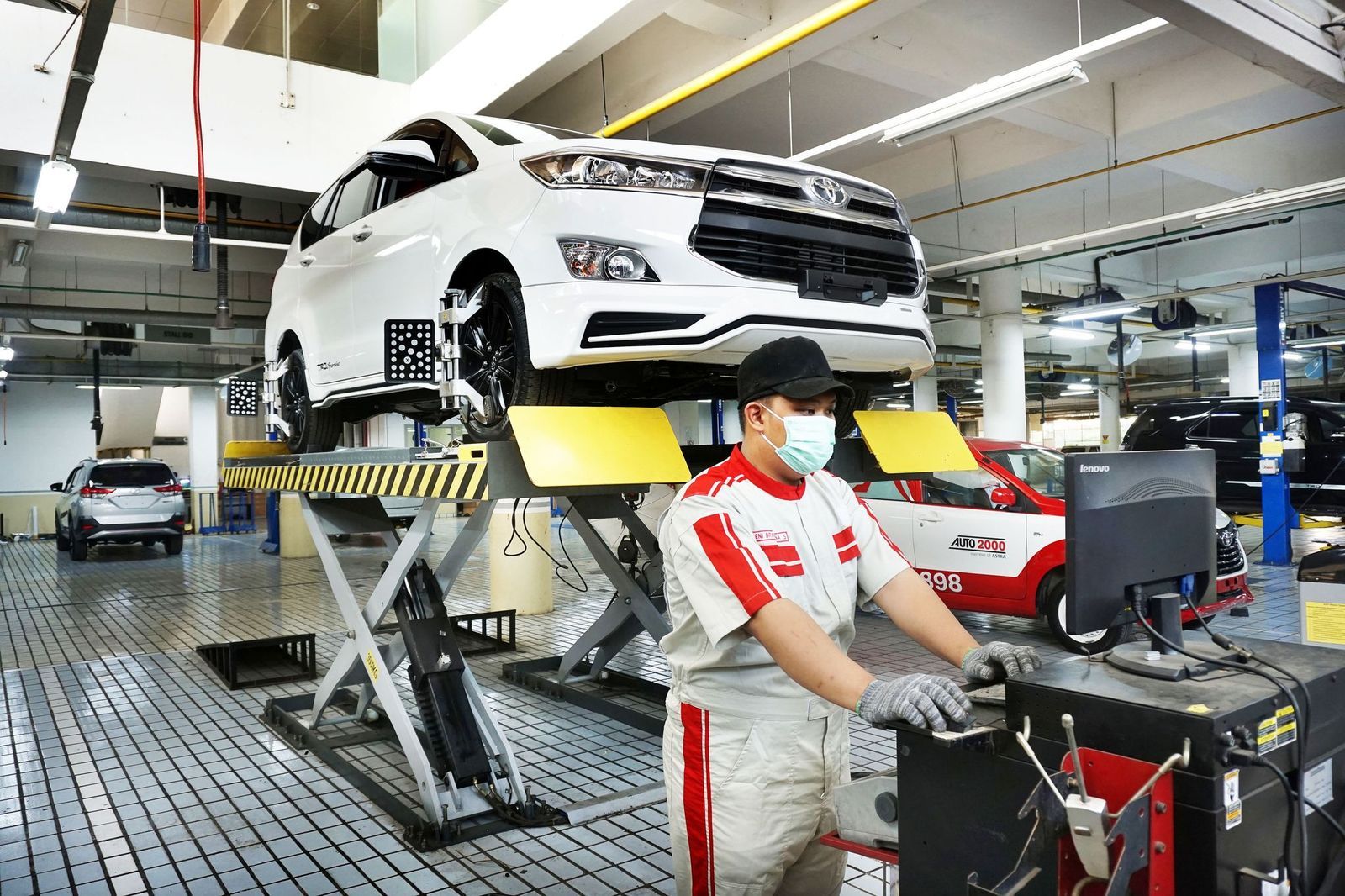 Ilustrasi mekanik sedang melakukan perbaikan atau servis mobil Toyota