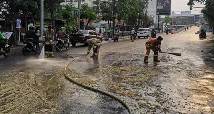 Petugas Diskar PB Kota Bandung, membersihkan tumpahan ampas tahu di Jalan Jakarta, Selasa 4 Mei 2021