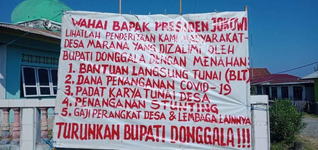 Spanduk curahan perasaan warga Desa Marana, Kecamatan Sindue, Donggala, Sulawesi Tengah.