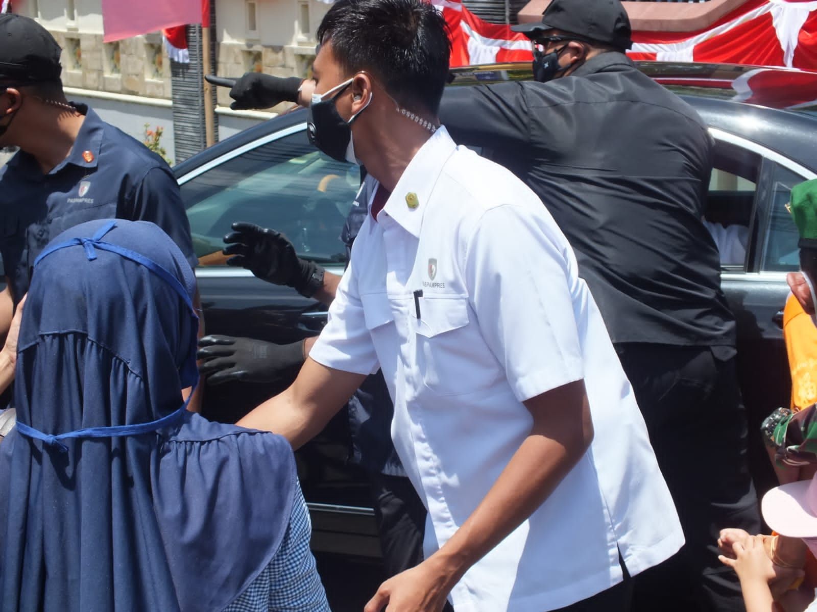 Seorang warga berusaha mendekat ke mobil yang ditumpangi Presiden Jokowi di Cilacap, 23 September 2021.
