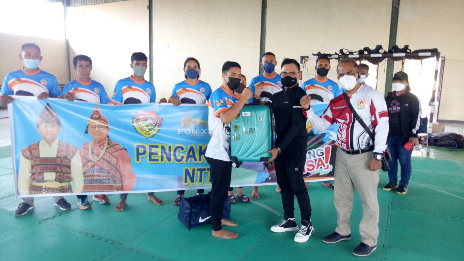 Ketua IPSI NTT, Andre Koreh didampingi Manager Pencak Silat NTT Dominggus D. Haga saat menyerahkan perlengkapan kepada atlet yang akan bertanding di PON Papua.   