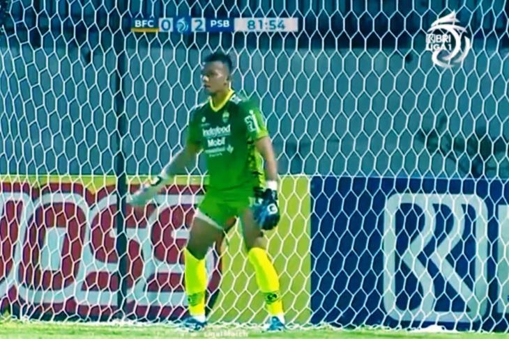 Penjaga gawang Persib Bandung Teja Paku Alam bersiap untuk menghadang tendangan eksekusi penalti Ezechiel Ndouassel . 