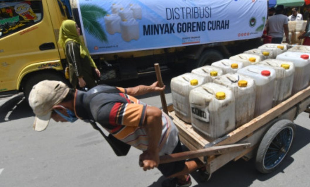 Kuli angkut membawa jeriken berisi minyak goreng curah yang dibeli dari PT Perusahaan Perdagangan Indonesia (Persero) di Pasar Masomba di Palu, Sulawesi Tengah, Jumat 18 Maret 2022. 