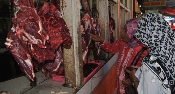 Seorang ibu sedang membeli daging sapi di Pasar Cikurubuk Kota Tasikmalaya. Jumlah pembeli daging sapi saat ini mulai menurun sehingga harganya yang saat lebaran mencapai Rp160.000 perkg, kini menjadi Rp130.000 perkg.* 