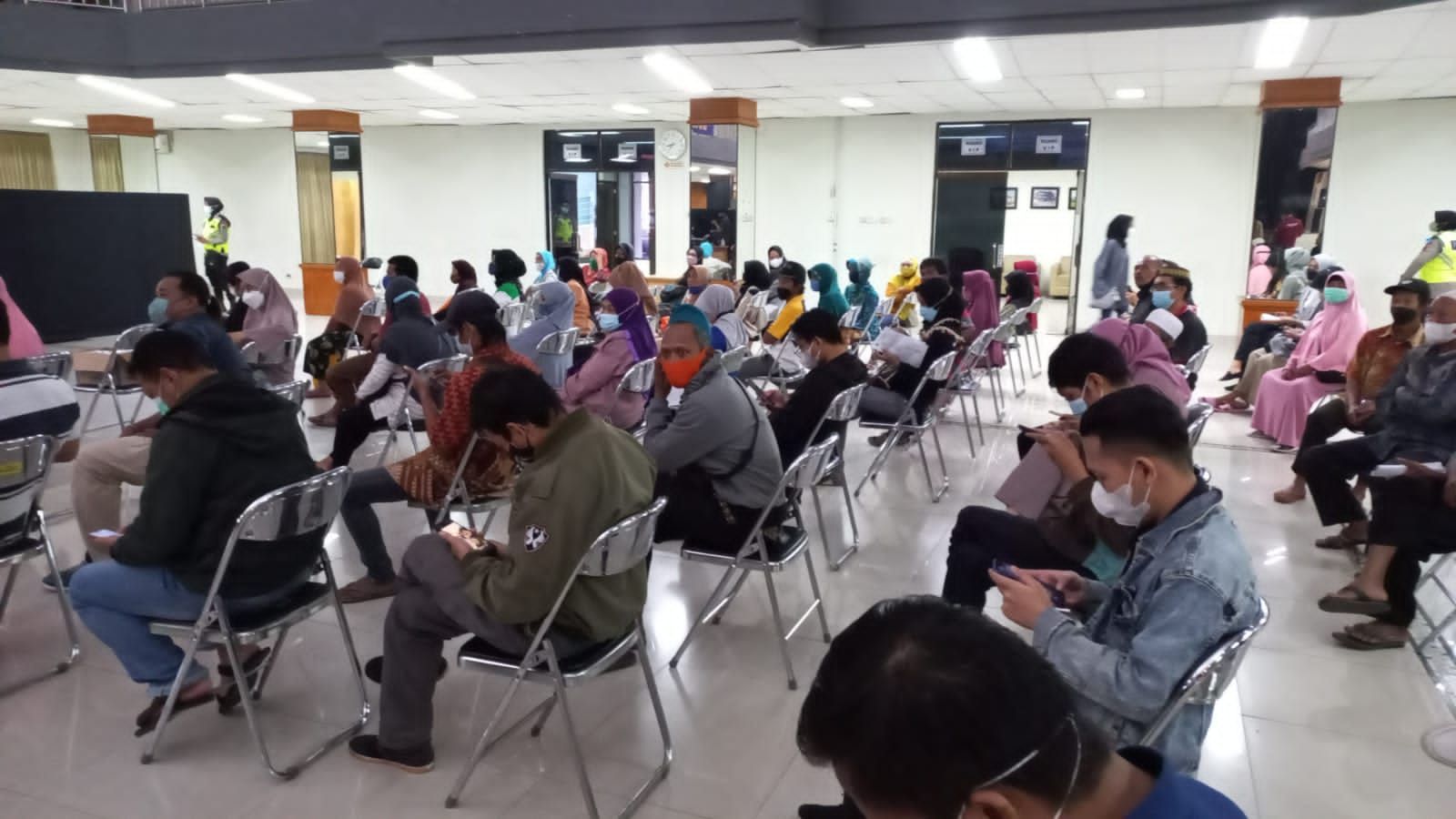 Warga mengantre sebelum mendapatkan vaksinasi booster di Universitas Muhammadiyah Purwokerto