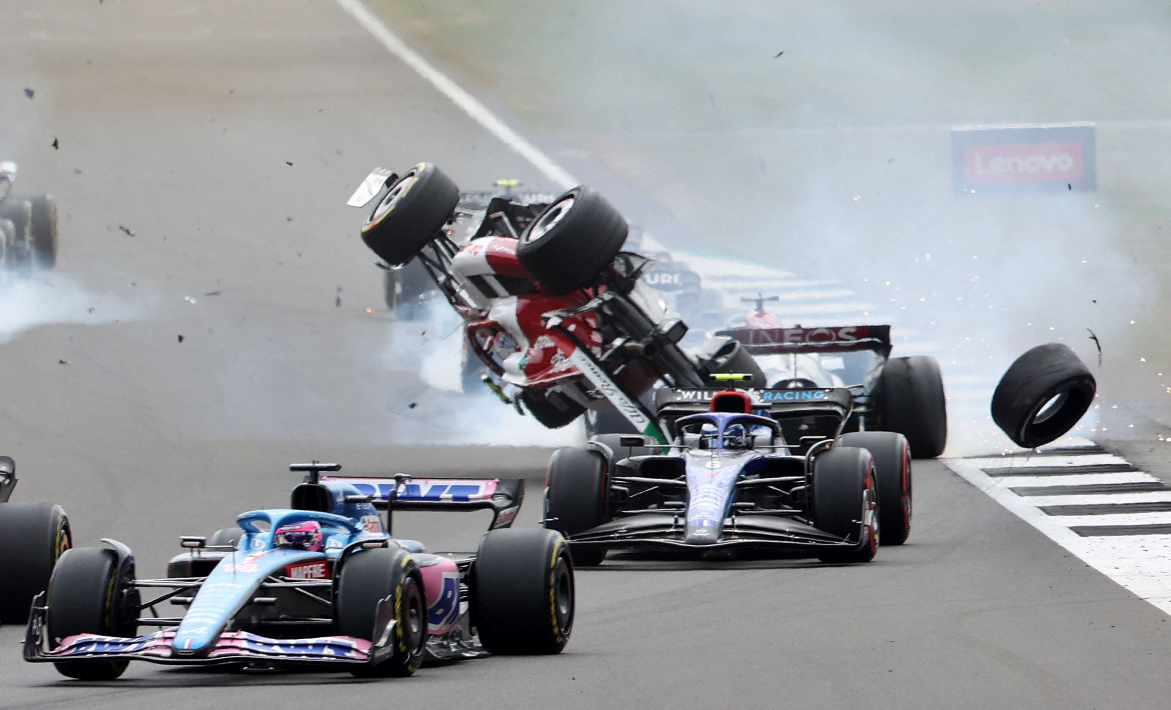Formula One F1 - British Grand Prix - Silverstone Circuit, Silverstone, Britain - July 3, 2022 Alfa Romeo's Guanyu Zhou crashes out at the start of the race REUTERS/Molly Darlington