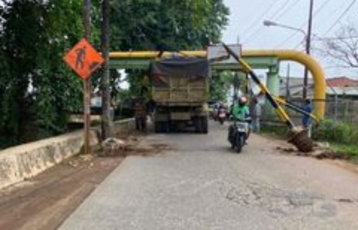 Portal pembatas jalan di Jalan Raya Krukut, Limo, Depok yang rusak parah usai dihantam truk tanah.