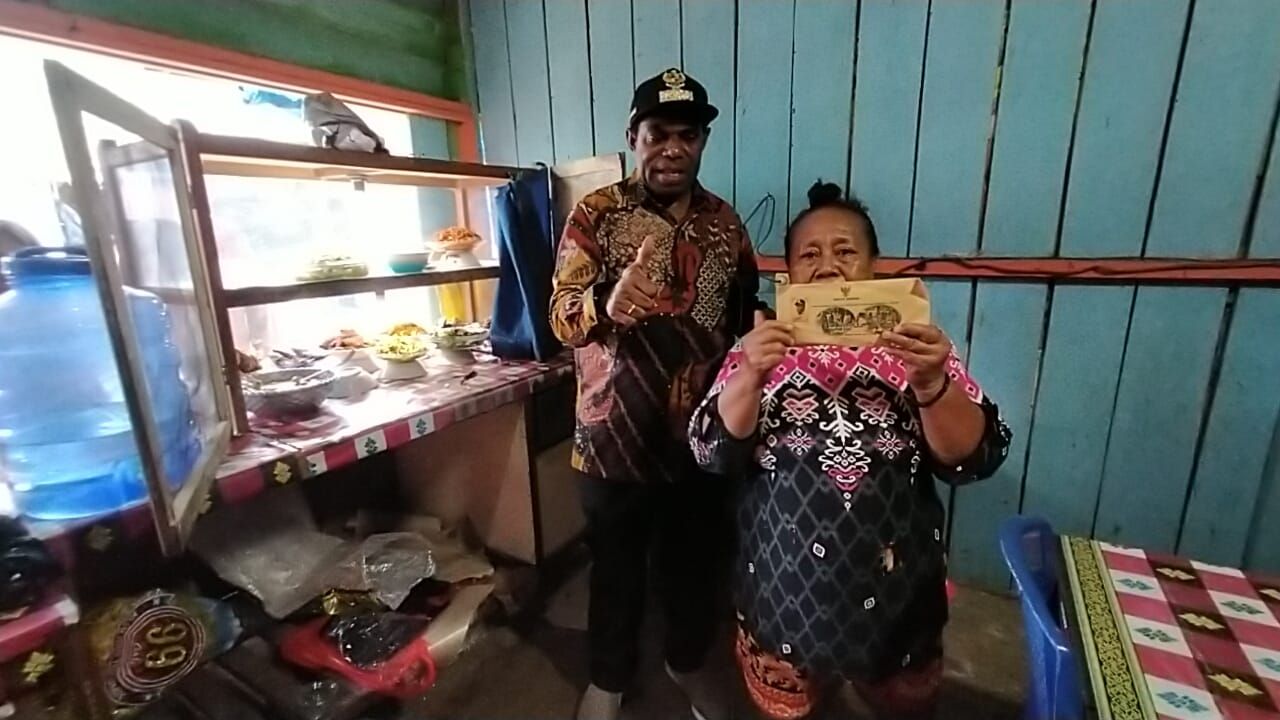 Salah seorang pengusaha warung makan UMKM di Pasar SP.I Kampung Woslay, Distrik Senggi, Ny. Kasmiati nampak terharu, saat Bupati Keerom, Piter Gusbager, SHut, MUP, menyerahkan bantuan modal usaha.