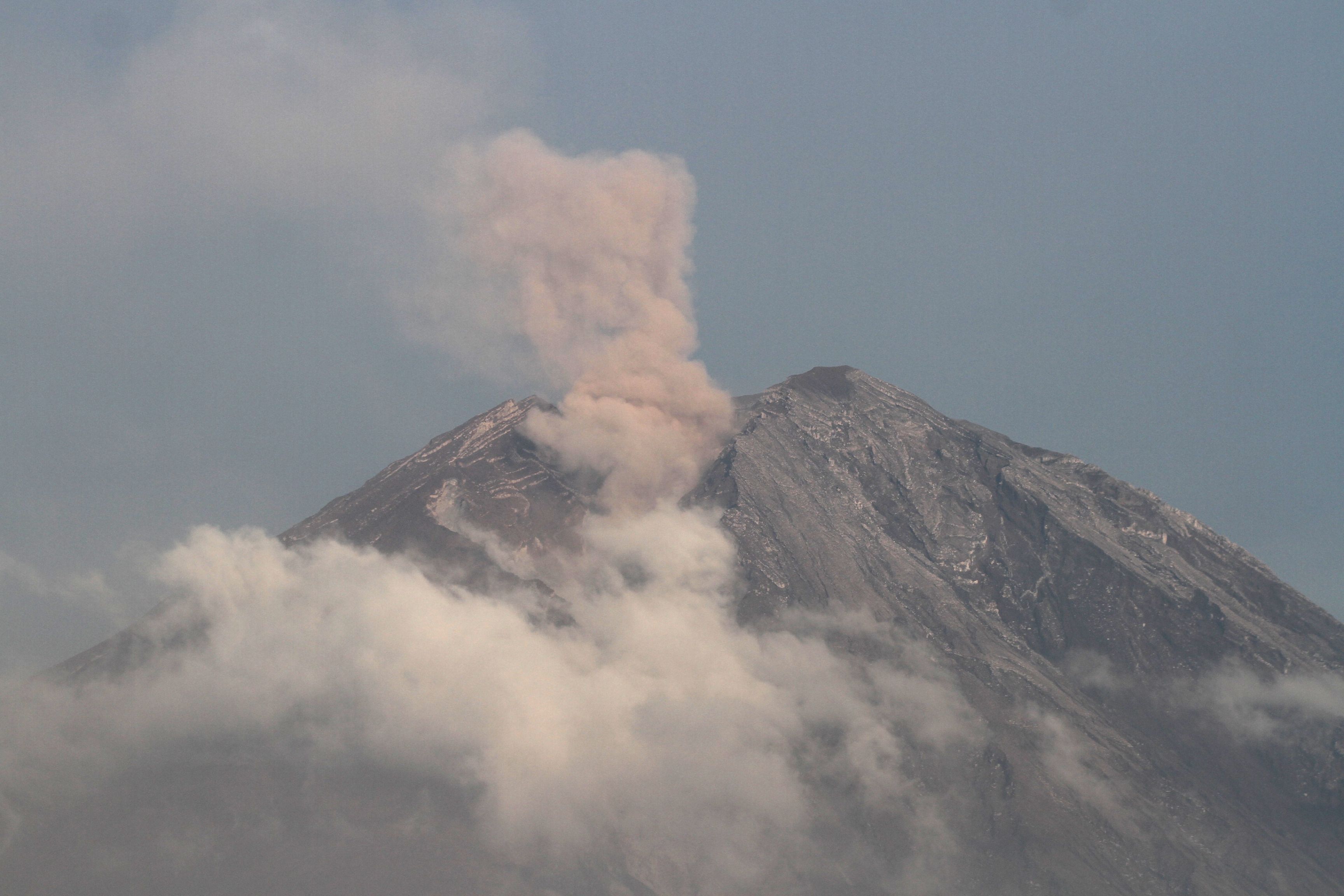 Gunung Semeru mengeluarkan material vulkanis yang terlihat dari desa Supiturang, Pronojiwo, Lumajang, Jawa Timur, Senin (5/12/2022).  Pusat Vulkanologi Mitigasi Bencana Geologi (PVMBG) mencatat gunung Semeru terus mengeluarkan material vulkanik yaitu pada periode pukul 24.00-0600 WIB mengalami 29 kali gempa letusan atau erupsi dengan amplitudo 11-22mm selama 65-120 detik, sekali gempa Awan Panas Guguran (APG) dengan amplitudo 25 mm selama 386 detik. ANTARA FOTO/Ari Bowo Sucipto/nym.