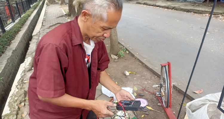 Bayu Aji, pria tua di Jalan Japati Kota Bandung bikin alat pembangkit listrik sederhana yang bisa cas HP dan Aki, Rabu 1 Februari 2023.