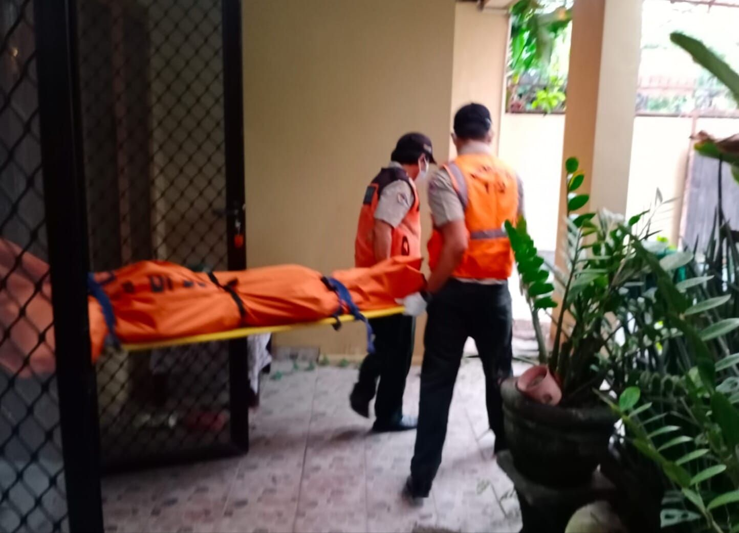 Petugas mengeluarkan jenazah mengering dari dalam rumah di Renon Denpasar Bali Kamis 2 Februari 2023.