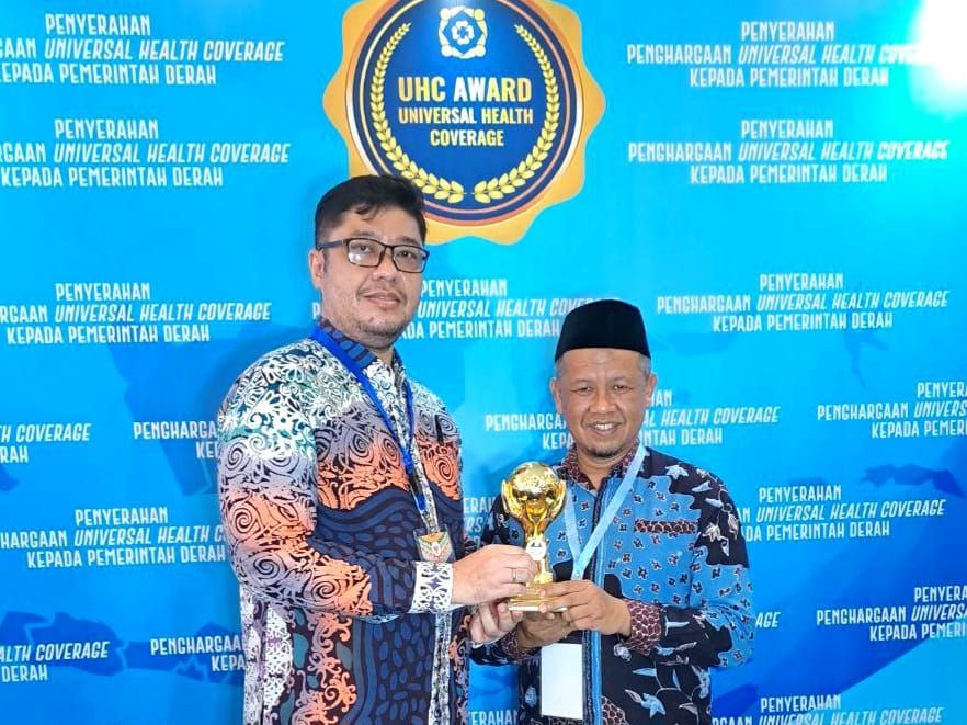 Kepala Dinas Kesehatan Kota Bandung, Anhar Hadian (kanan) menerima UHC Award.
