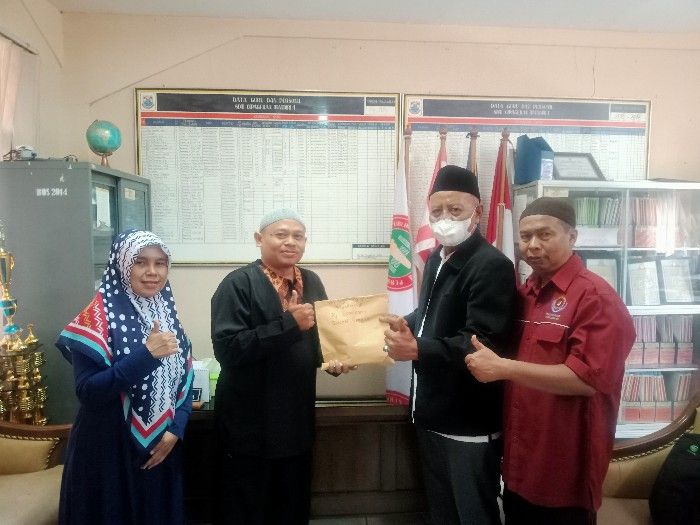 Kepala SDN Cipageran Mandiri 1 Cimahi, Aep Dedi Sudiana S PD menyerahkan donasi program Kado Lebaran  untuk Korban Gempa Cianjur kepada perwakilan Al Quds Volunteer Indonesia
