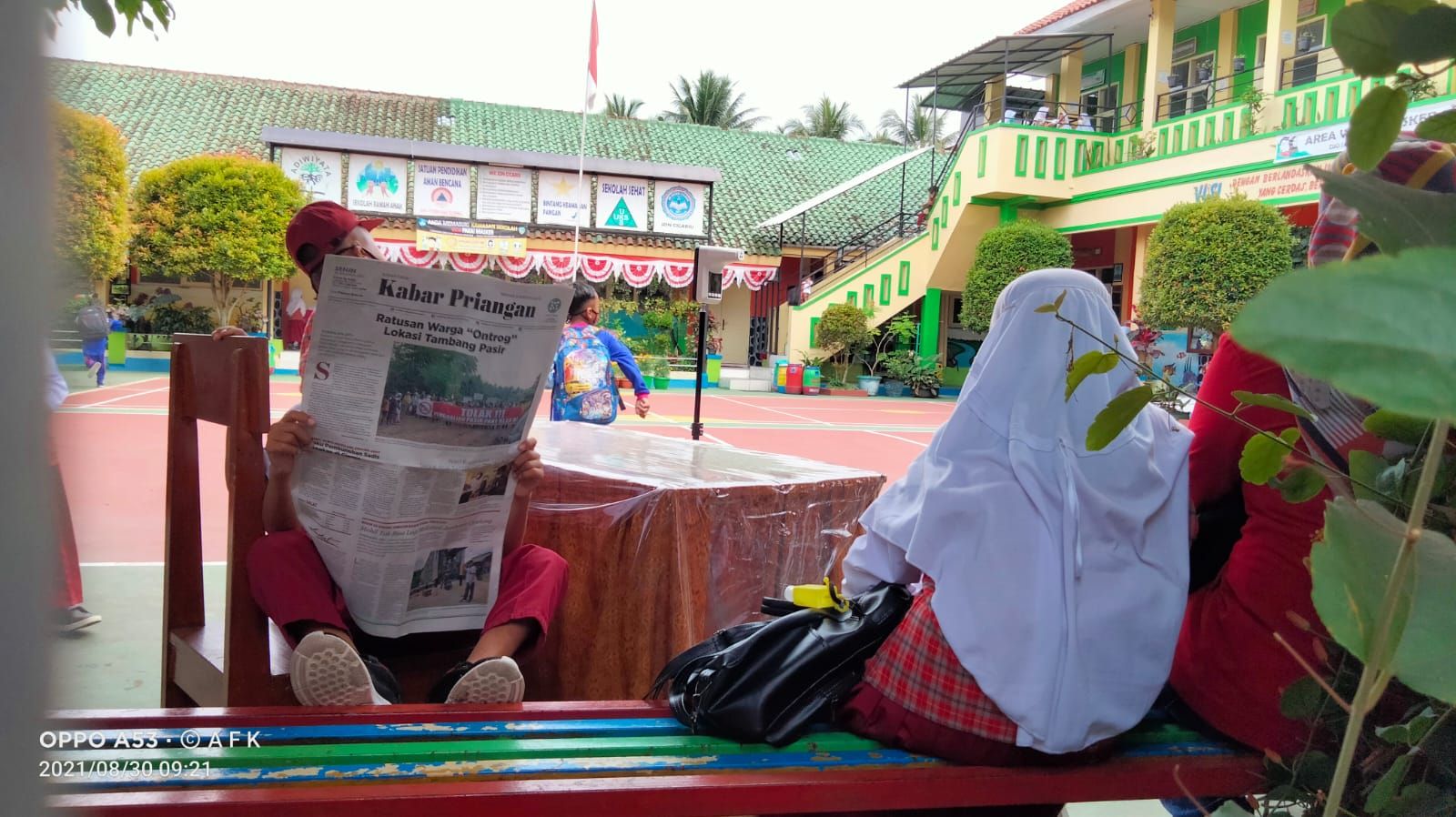 Seorang siswa SD di Kota Tasikmalaya asyik membaca Harian Umum Kabar Priangan saat jam istirahat belajar, 30 Agustus 2021.*/kabar-priangan.com/Arief Farihan Kamil