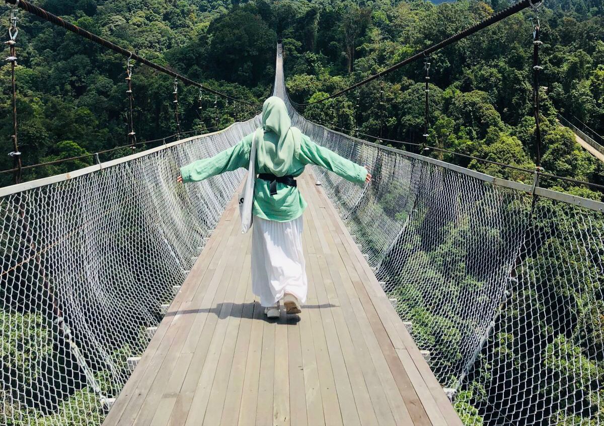 Salah seorang wisatawan sedang menikmati pesona keindahan pemandangan Jembatan Gantung Situ Gunung, Sukabumi/