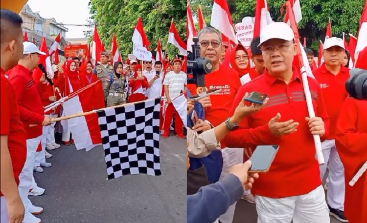 Gubernur Bengkulu, Rohidin Mersyah, memimpin acara ini dengan penuh semangat, turut serta dalam pembagian bendera merah putih kepada masyarakat./foto: tiktok @petualang13/