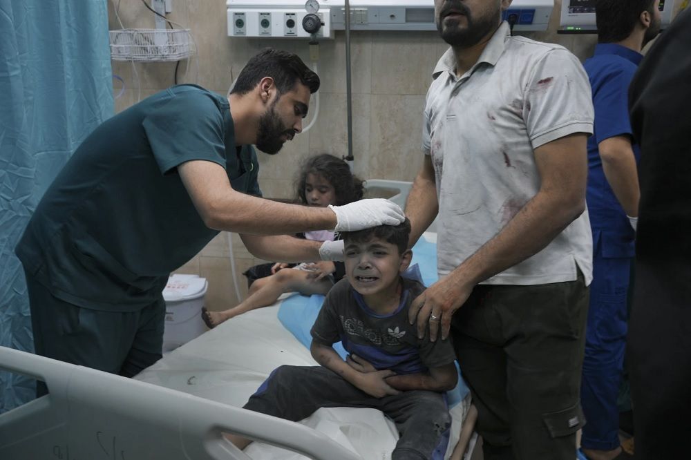Seorang anak laki laki terluka dalam pemboman Israel di jalur Gaza mangis kesakitan di Deir al Balah jalur selatan Gaza, 21 Oktober 202. AP Photo-Hatem Moussa