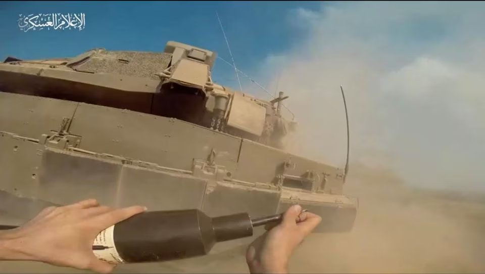 Seorang pejuang Hamas Palestina menempatkan bahan peledak di tank Israel di Jalur Gaza, diperoleh 2 November 2023.