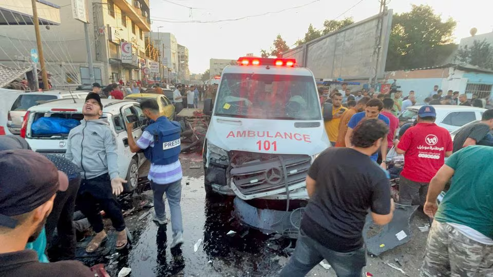 Warga Palestina memeriksa kerusakan setelah konvoi ambulans dihantam bom Israel, di pintu masuk rumah sakit Shifa di Jalur Gaza, 3 November 2023. /REUTERS/Mohammed Al-Masri