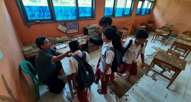 Sejumlah murid mencium tangan Endang Hidayat (58), guru di SDN Cibungur kelas jauh Cijuhung saat pulang sekolah di Kampung Cijuhung, Desa Margaluyu, Kecamatan Cipeundeuy, Kabupaten Bandung Barat, Selasa, 28 November 2023.
