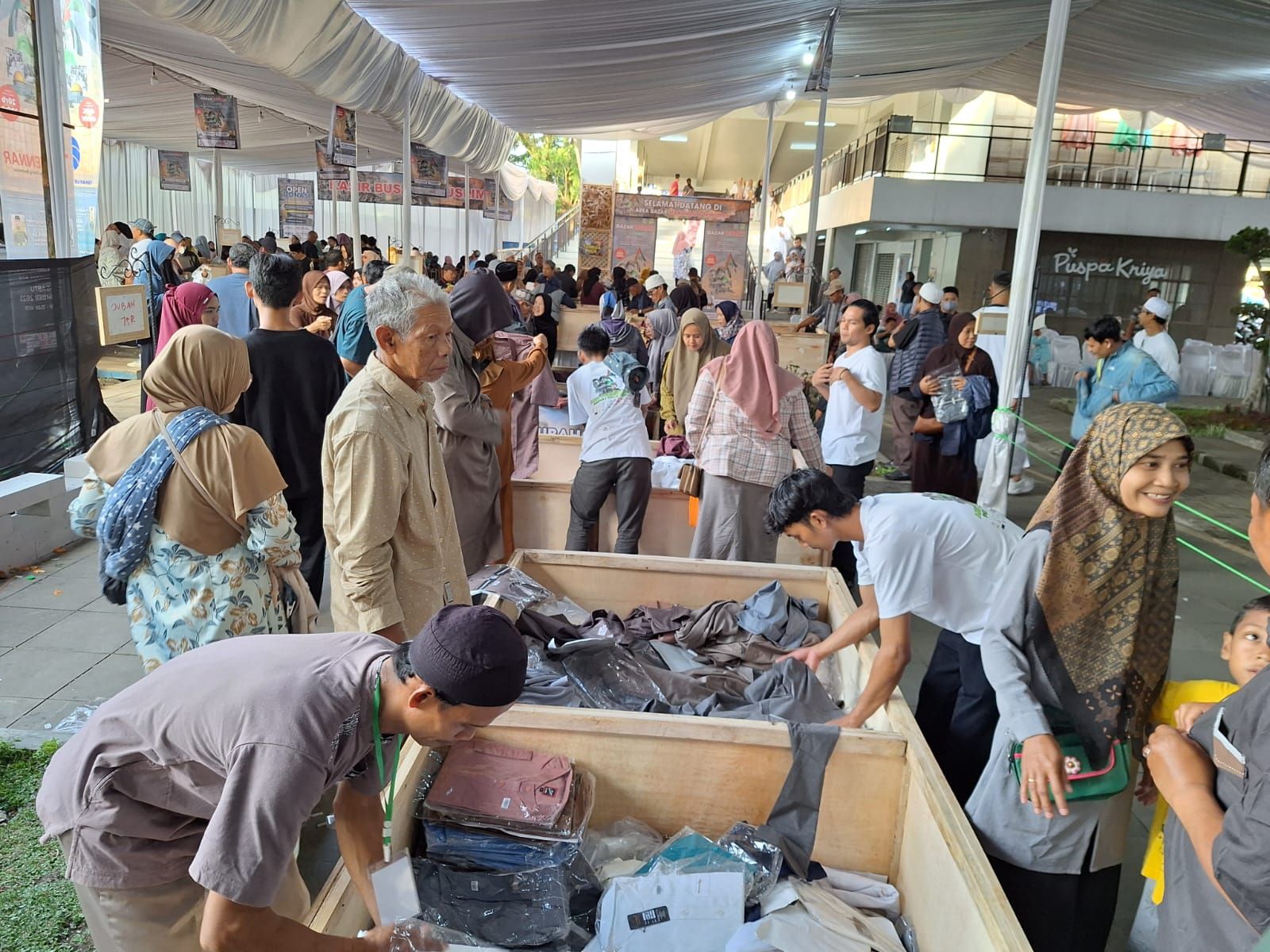 Tidak hanya ibu-ibu, bapak-bapak juga terlihat antusias memilih busana muslim yang ada di bazar murah busana muslim dan makanan Peduli Palestina di GCC Dadaha Tasikmalaya, Kamis 14 Desember 2023.