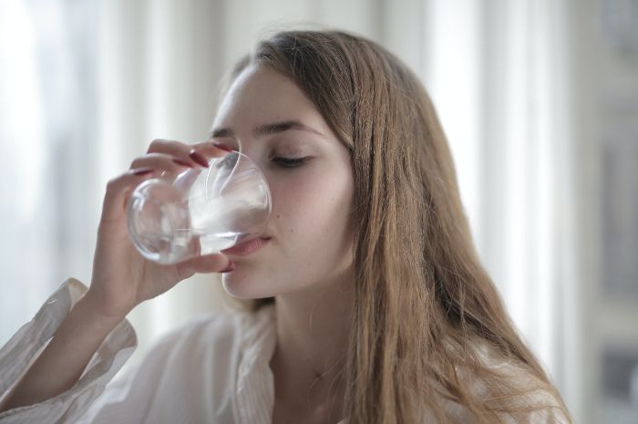 Ilustrasi minum air putih, bisa mencegah batu ginjal serta infeksi kandung kemih.