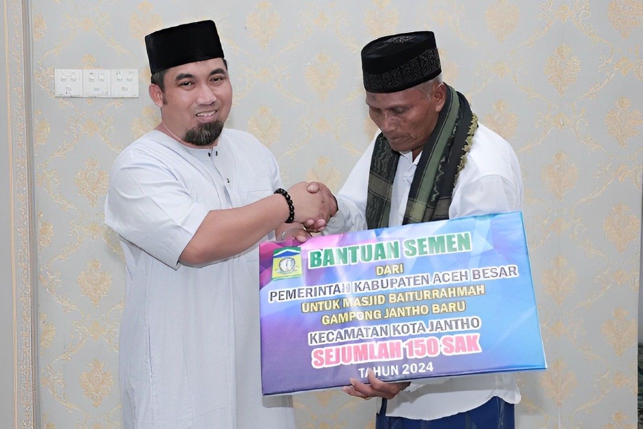 Pj Bupati Aceh Besar Muhammad Iswanto SSTP MM, menyerahkan bantuan material pembangunan untuk Masjid Baiturrahmah Jantho Baru secara simbolis kepada Imam Masjid Tgk Muhammad Juned.